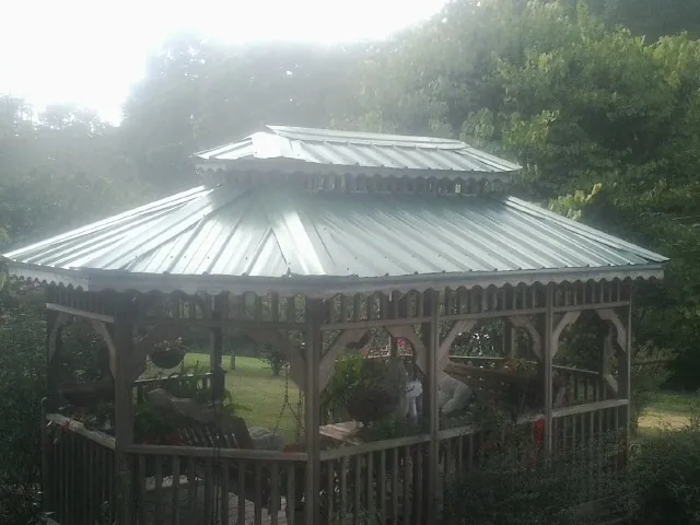 Two tier green metal roof on a garden gazebo in Grantsville